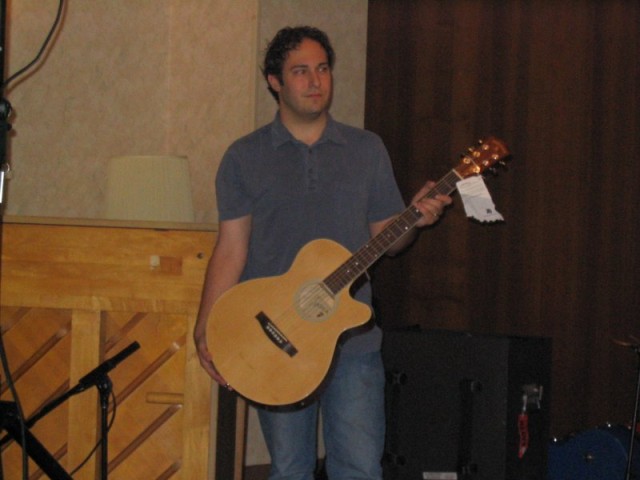 Arron holding the auction guitar