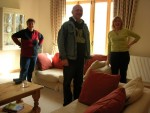 While checking out the living room, Rowy, DavidUK and Anne stop to smile at Chet's camera